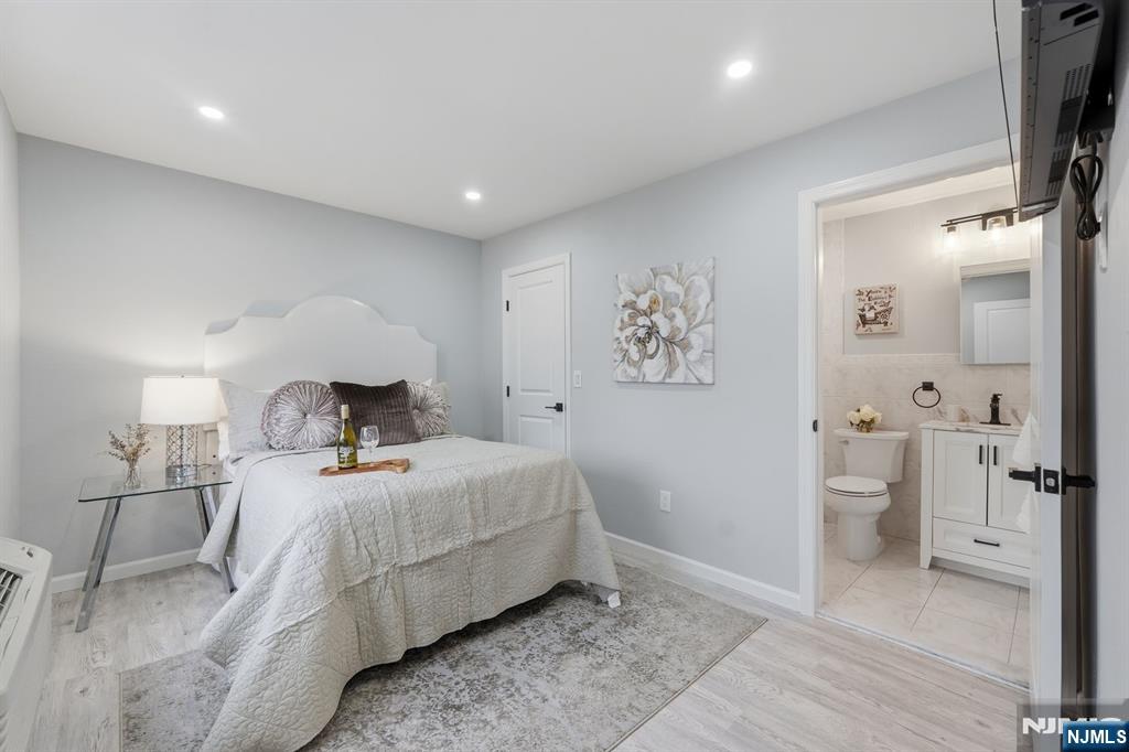 9 Vreeland Street, Unit 2F Hackensack, NJ 07601 - Photo 11 of 20 a bedroom with a bed and a view of bathroom