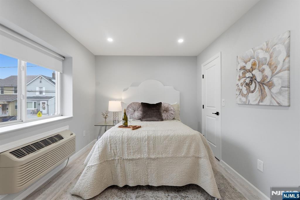 9 Vreeland Street, Unit 2F Hackensack, NJ 07601 - Photo 12 of 20 a bedroom with a bed and a painting on the wall