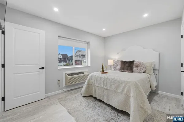a bedroom with a bed and a painting on the wall