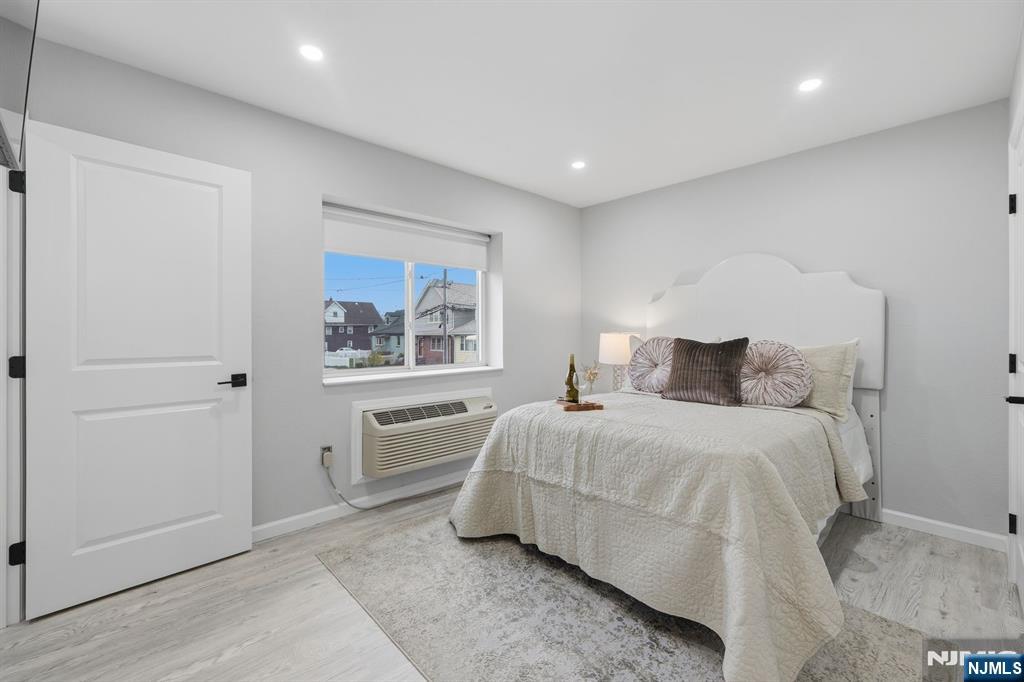9 Vreeland Street, Unit 2F Hackensack, NJ 07601 - Photo 13 of 20 a bedroom with a bed and a painting on the wall