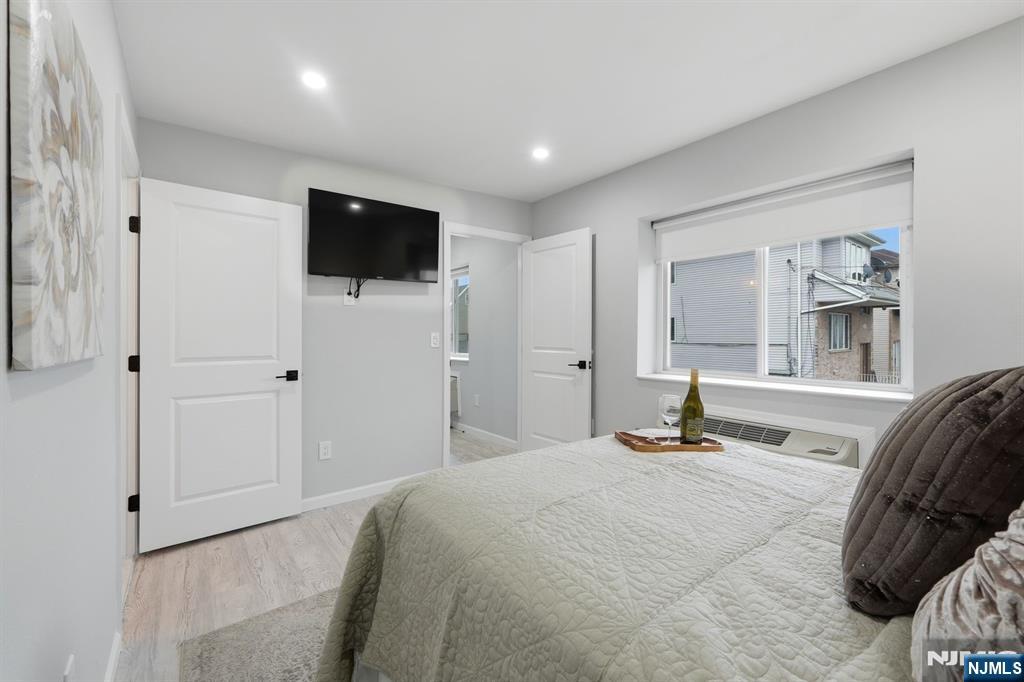 9 Vreeland Street, Unit 2F Hackensack, NJ 07601 - Photo 14 of 20 a bedroom with a bed and a flat screen tv