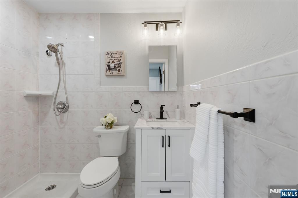 9 Vreeland Street, Unit 2F Hackensack, NJ 07601 - Photo 15 of 20 a bathroom with a sink a toilet and shower