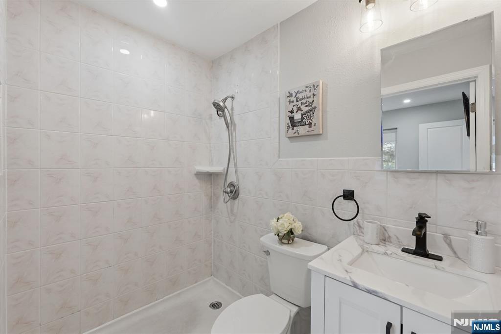 9 Vreeland Street, Unit 2F Hackensack, NJ 07601 - Photo 16 of 20 a bathroom with a sink toilet and shower