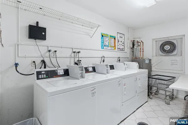 a view of storage and utility room with two washing machine