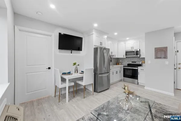 a kitchen with a refrigerator and a stove top oven