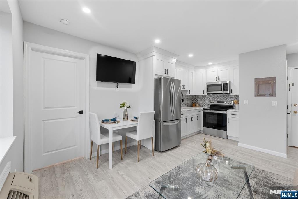 9 Vreeland Street, Unit 2F Hackensack, NJ 07601 - Photo 8 of 20 a kitchen with a refrigerator and a stove top oven