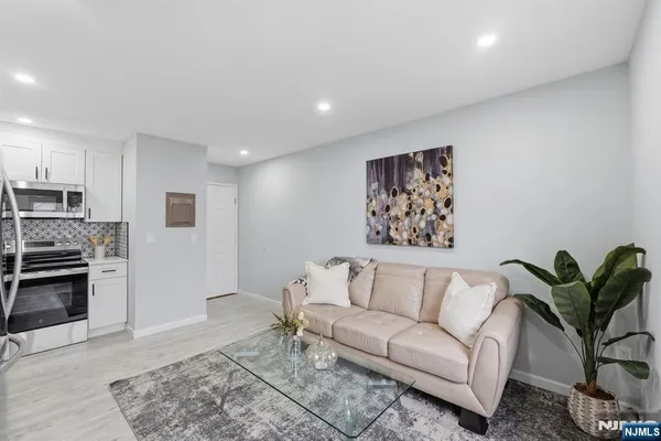 a living room with furniture a couch and a potted plant