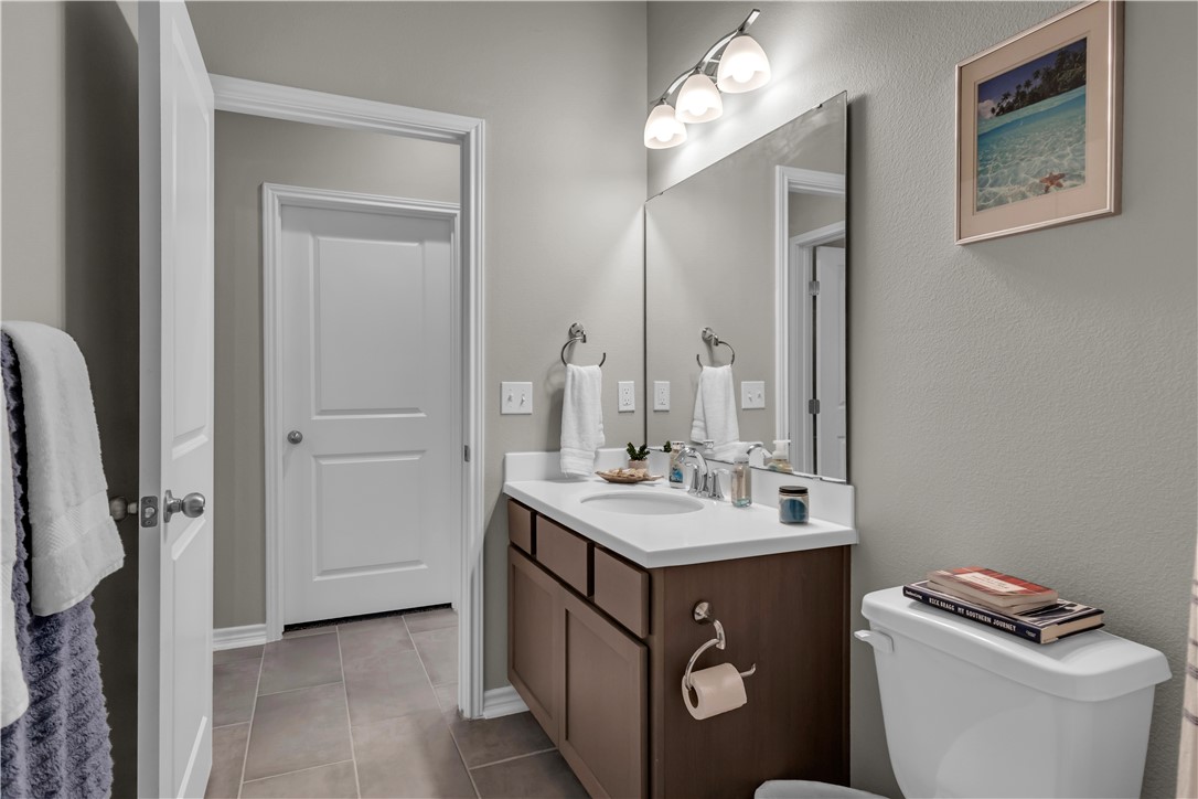 1033 Ocean Breeze Portland, TX 78374 - Photo 11 of 38 a bathroom with a toilet sink and mirror