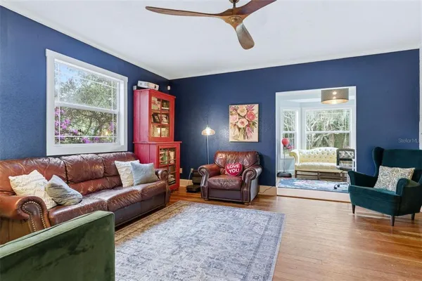 a living room with furniture and a floor to ceiling window