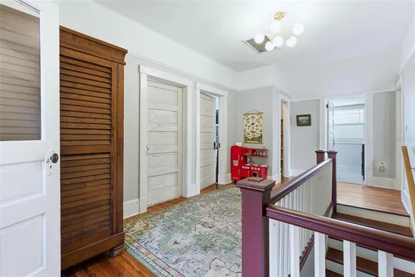 a dining room with furniture and potted plant