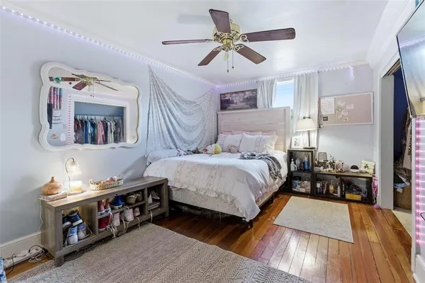 a bedroom with a bed and wooden floor