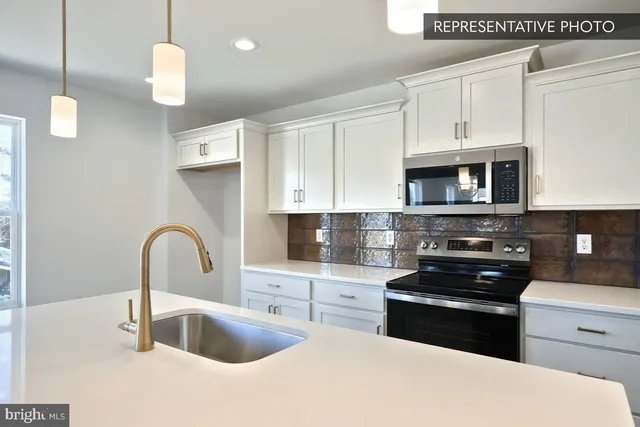 a view of a room with wooden floor and windows