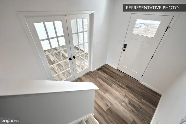 a bathroom with a sink a toilet and a large mirror