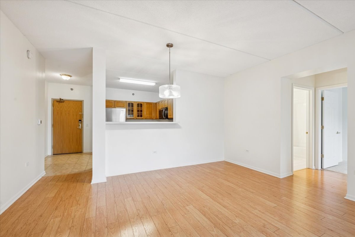 440 West Mahogany Court, Unit 203 Palatine, IL 60067 - Photo 6 of 17 a view of a room with wooden floor and a ceiling fan