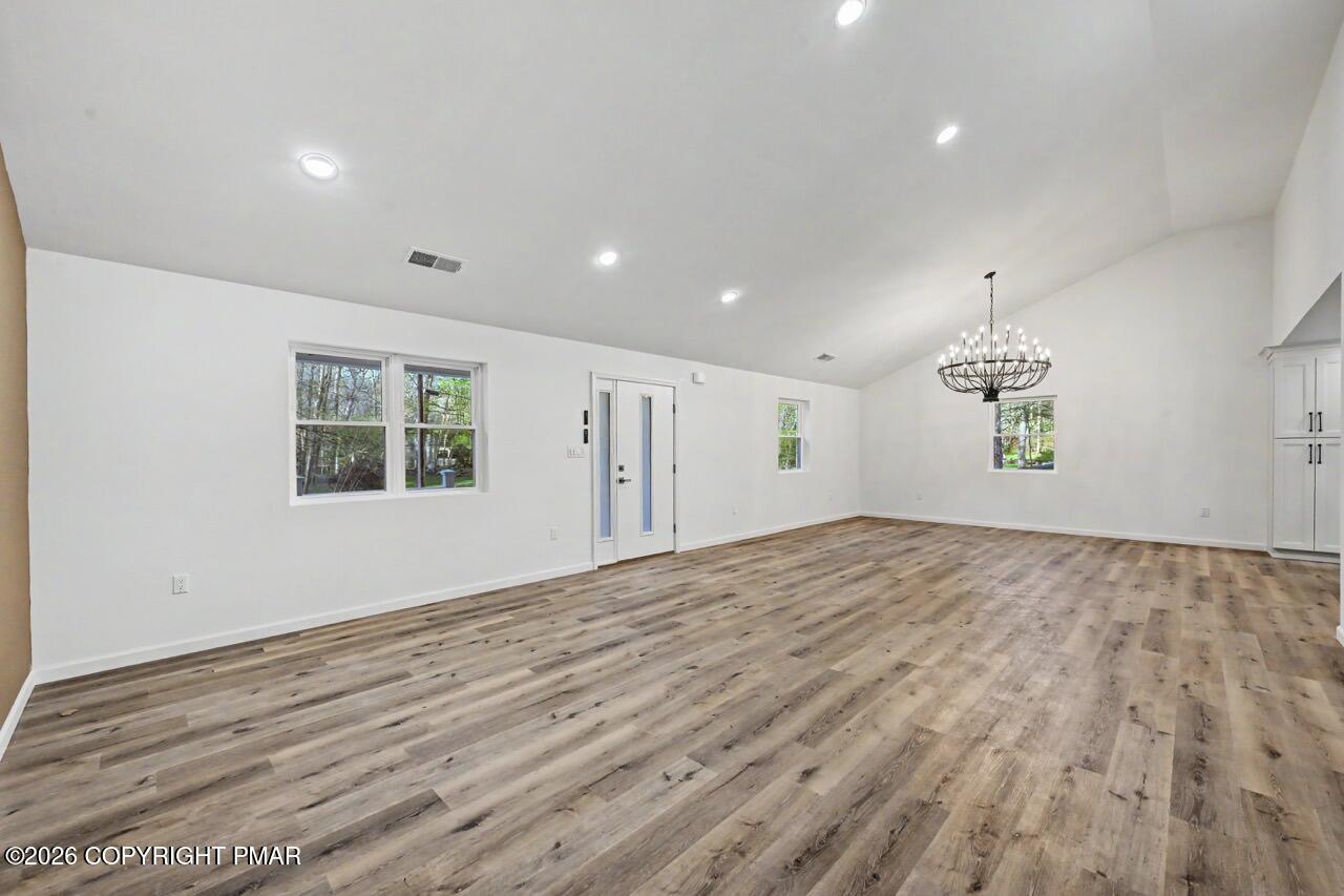 1131 Mink Court Bushkill, PA 18324 - Photo 17 of 81 a view of empty room with wooden floor and window