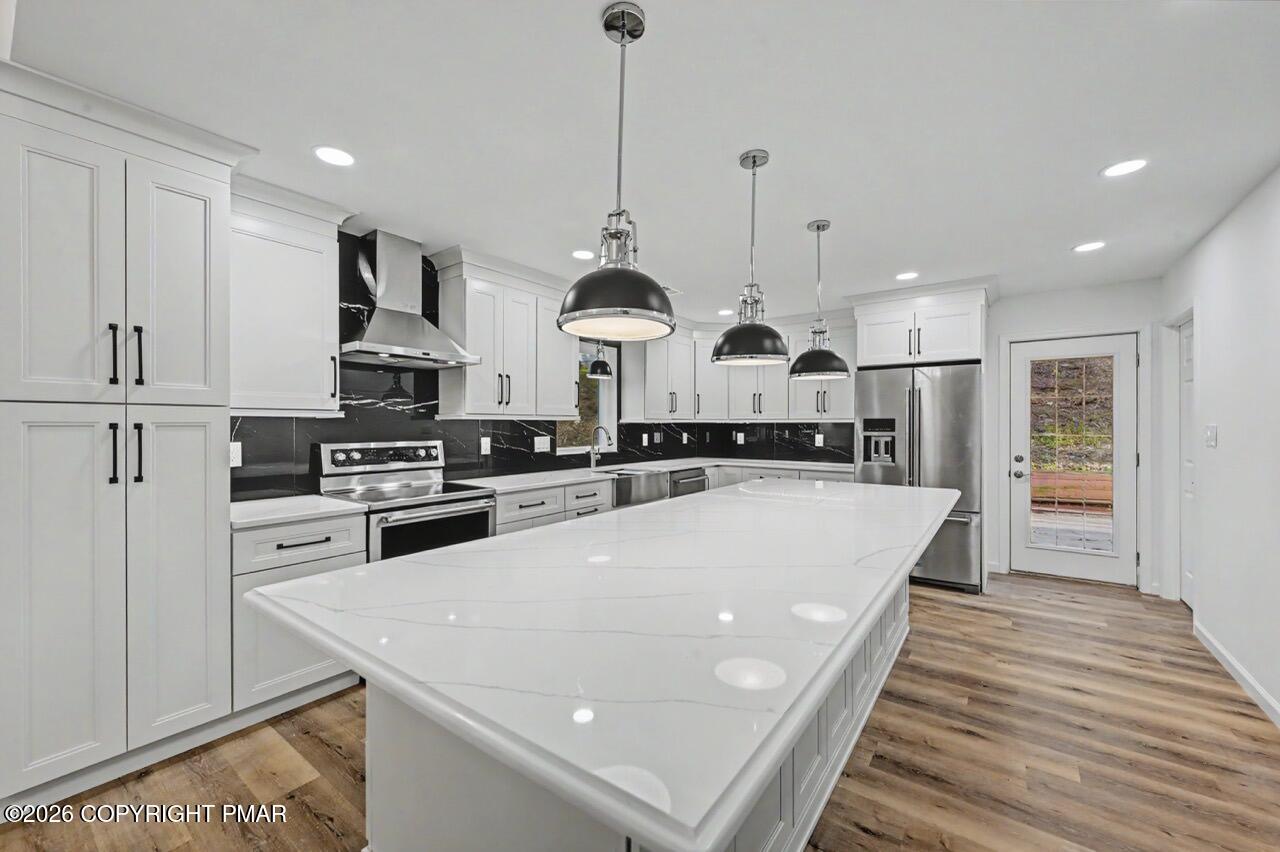 1131 Mink Court Bushkill, PA 18324 - Photo 26 of 81 a large kitchen with stainless steel appliances and white cabinets
