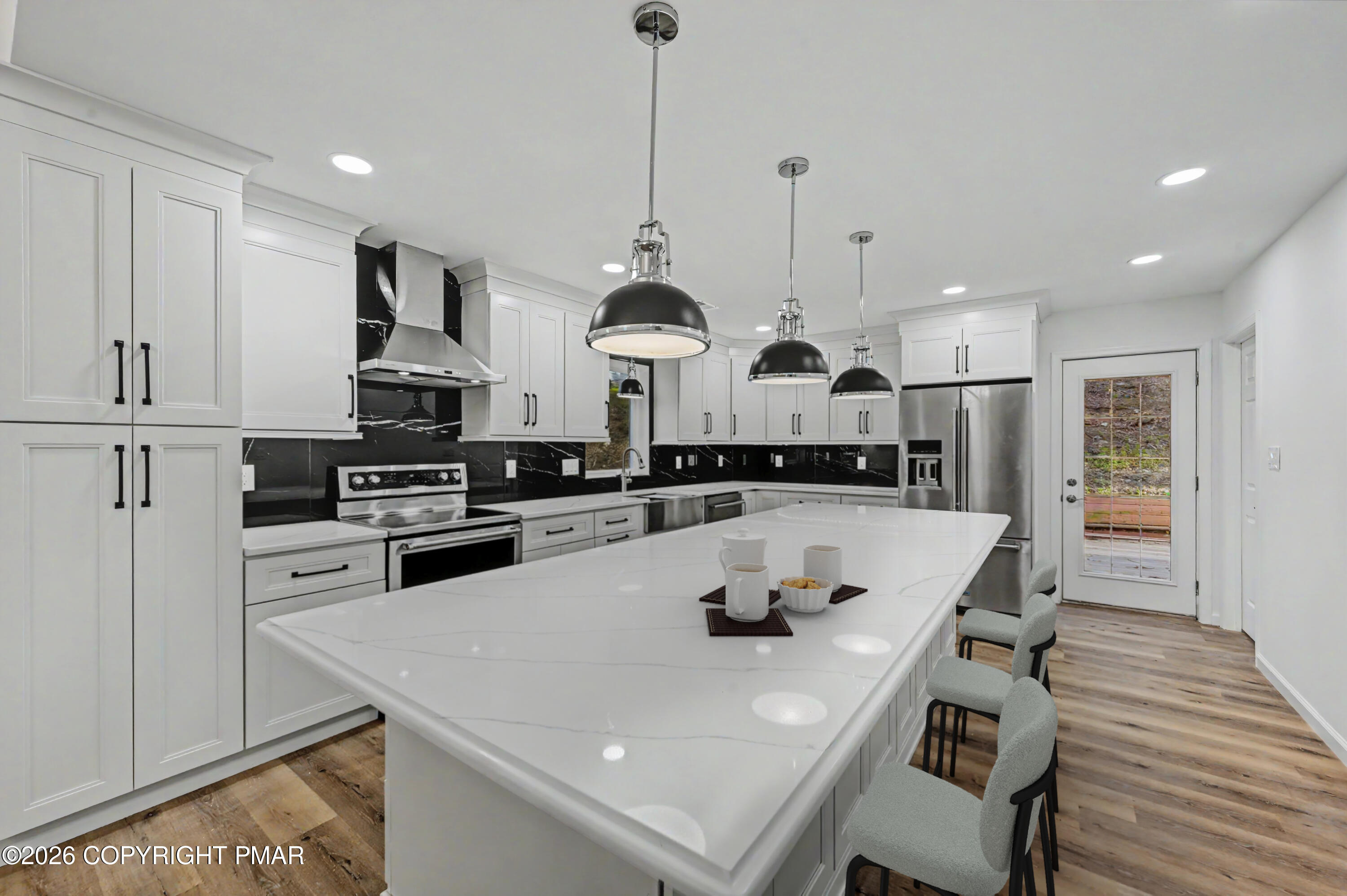 1131 Mink Court Bushkill, PA 18324 - Photo 27 of 81 a kitchen with stainless steel appliances granite countertop a sink a stove and a refrigerator