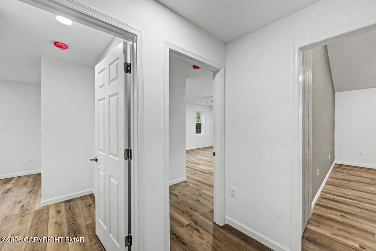 1131 Mink Court Bushkill, PA 18324 - Photo 36 of 81 a view of a hallway with wooden floor and closet
