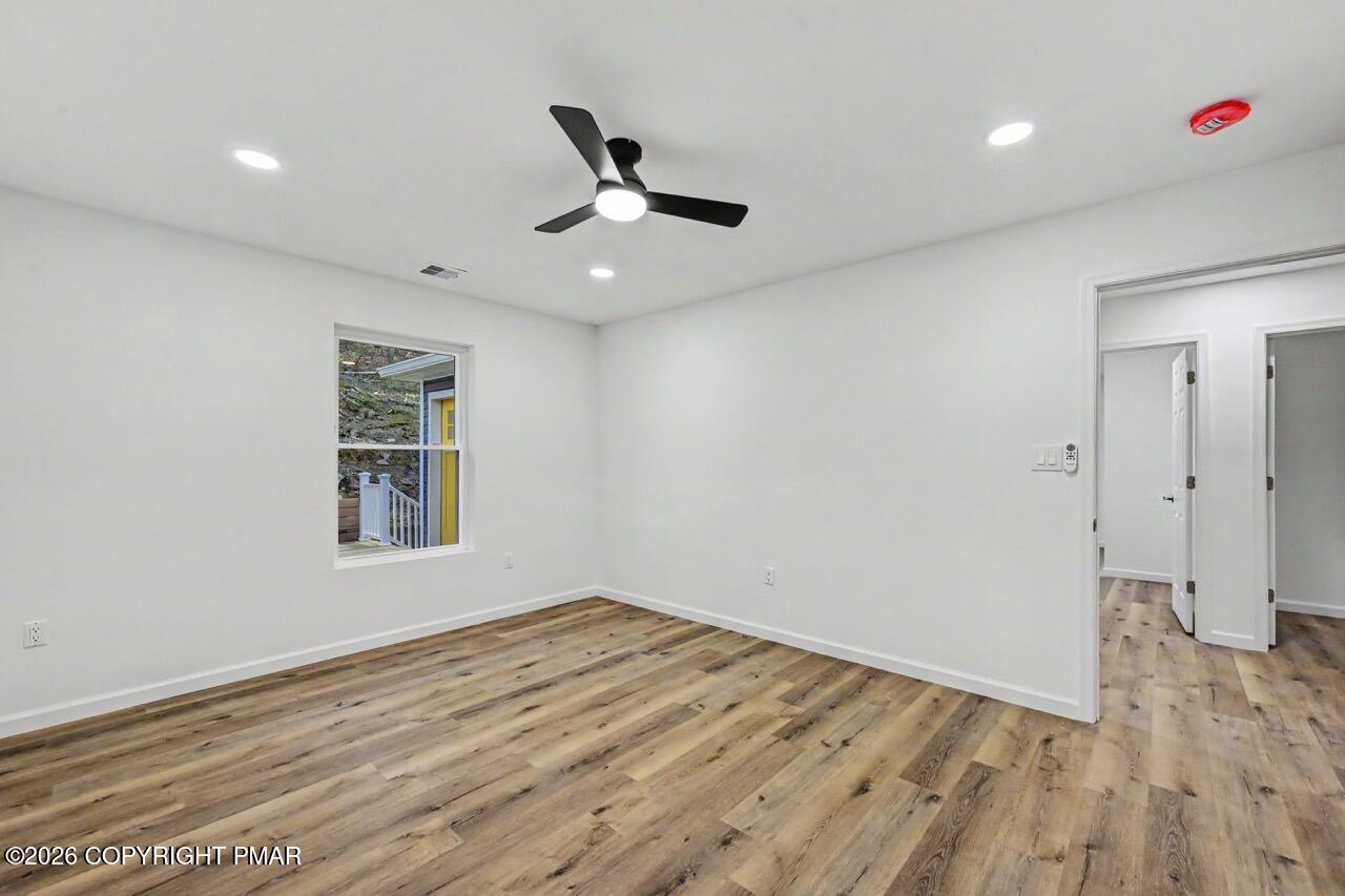 1131 Mink Court Bushkill, PA 18324 - Photo 46 of 81 a view of empty room with wooden floor and fan