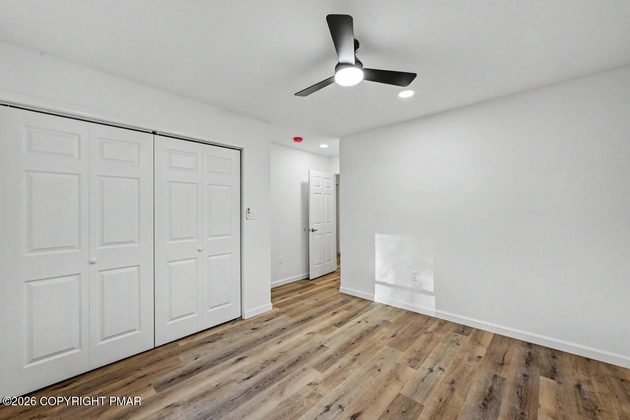 1131 Mink Court Bushkill, PA 18324 - Photo 50 of 81 a view of empty room with wooden floor