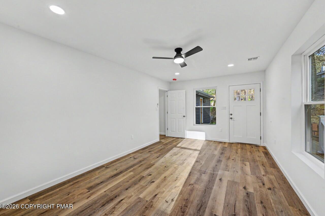 1131 Mink Court Bushkill, PA 18324 - Photo 57 of 81 wooden floor in an empty room with a window