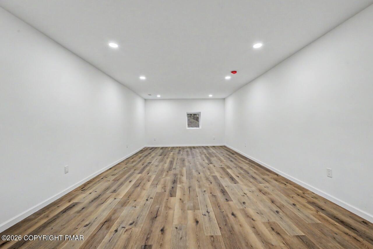 1131 Mink Court Bushkill, PA 18324 - Photo 66 of 81 a view of empty room with wooden floor