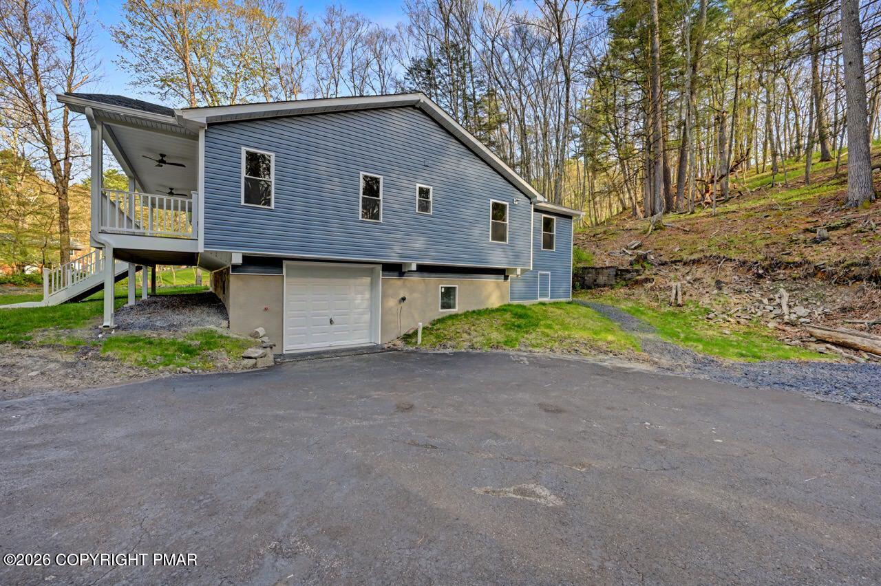1131 Mink Court Bushkill, PA 18324 - Photo 78 of 81 a front view of a house with a yard and garage