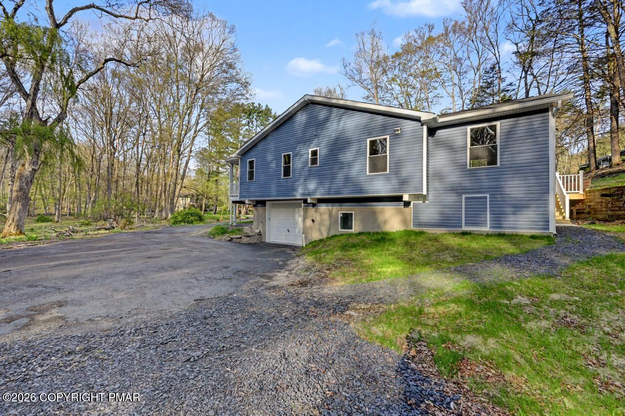 1131 Mink Court Bushkill, PA 18324 - Photo 79 of 81 a front view of house with yard and trees in the background