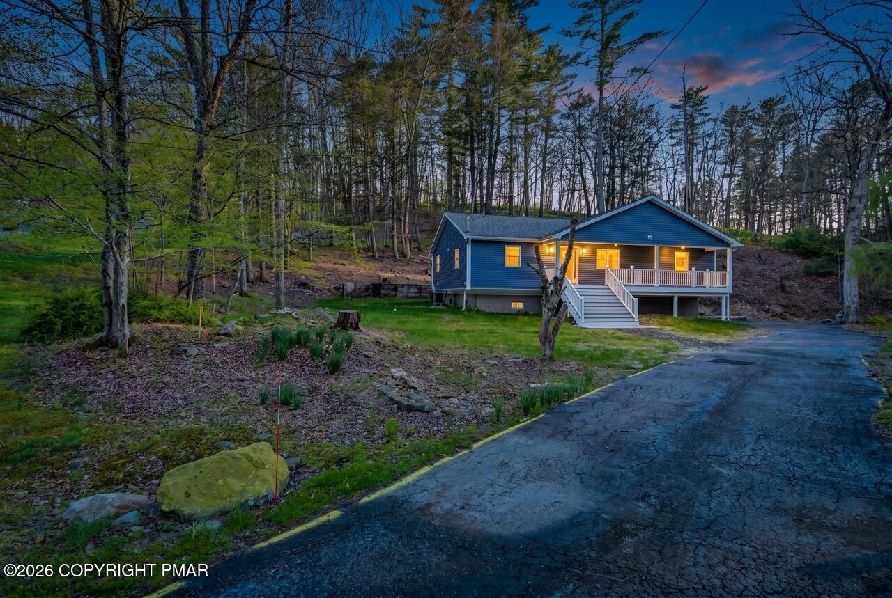 1131 Mink Court Bushkill, PA 18324 - Photo 8 of 81 a front view of a house with garden and trees