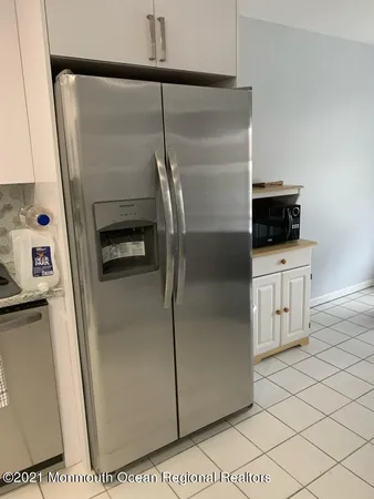a kitchen with a refrigerator a stove and a sink
