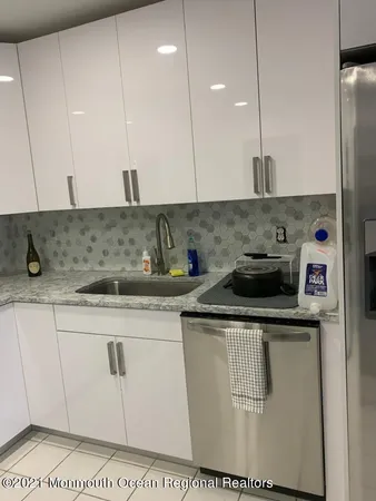 a kitchen with stainless steel appliances granite countertop a sink a stove and a refrigerator