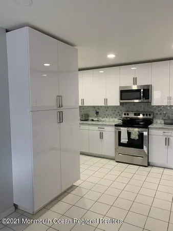 a kitchen with stainless steel appliances a stove a sink and a refrigerator