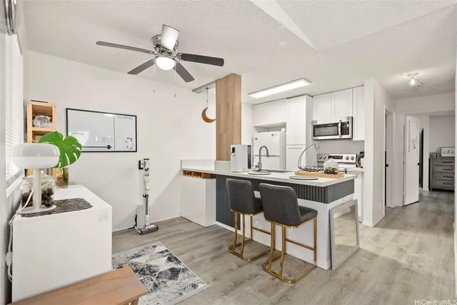 a kitchen with a table chairs refrigerator and cabinets