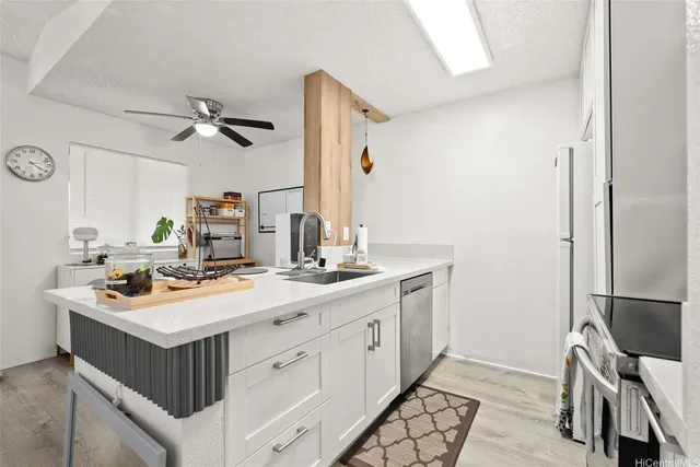 a view of a dining room with furniture a rug and wooden floor