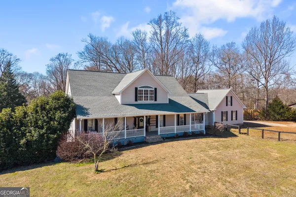 a view of a house with snow on the road