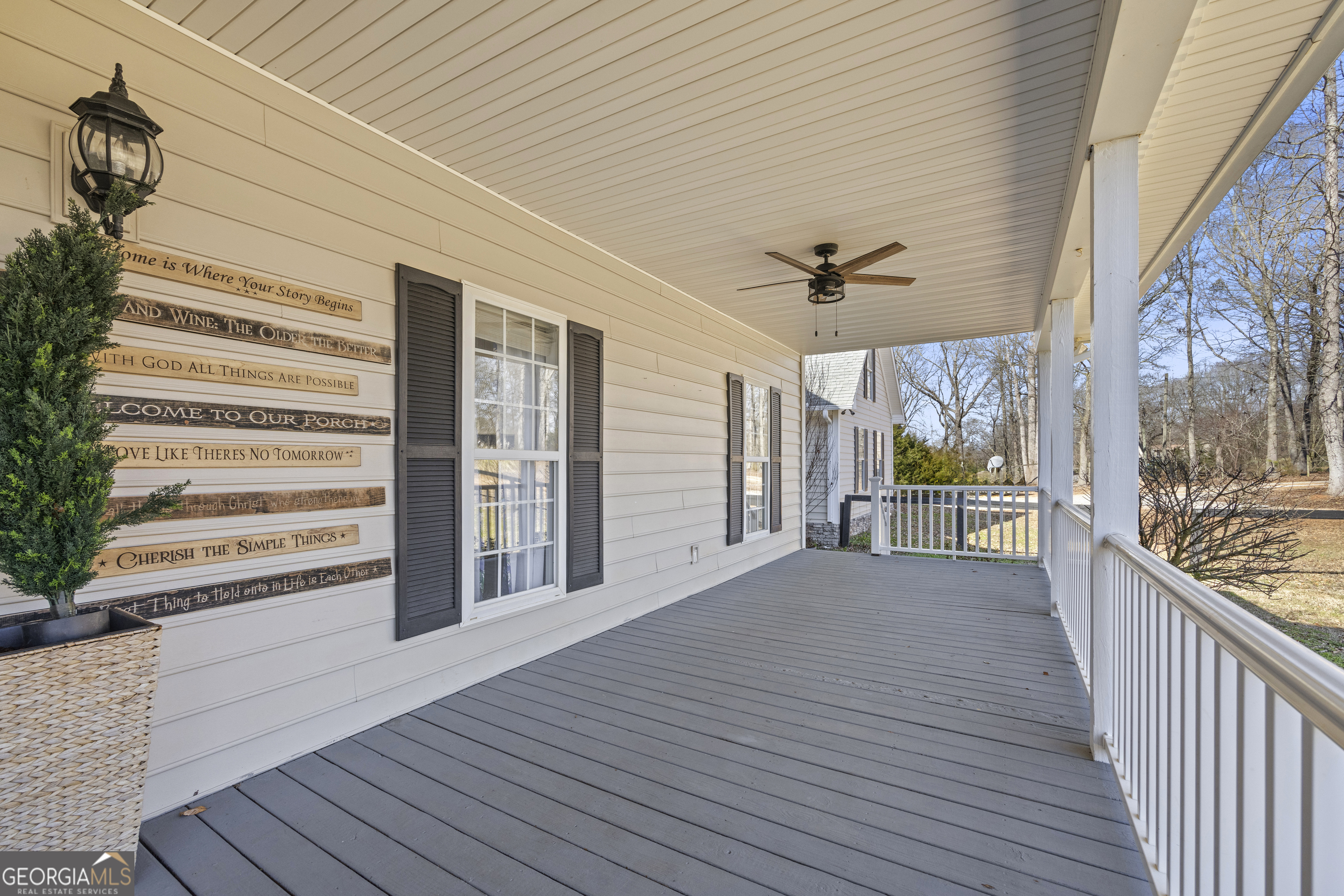 2565 New Franklin Church Road Canon, GA 30520 - Photo 122 of 168 a view of a balcony with wooden floor and a ceiling fan