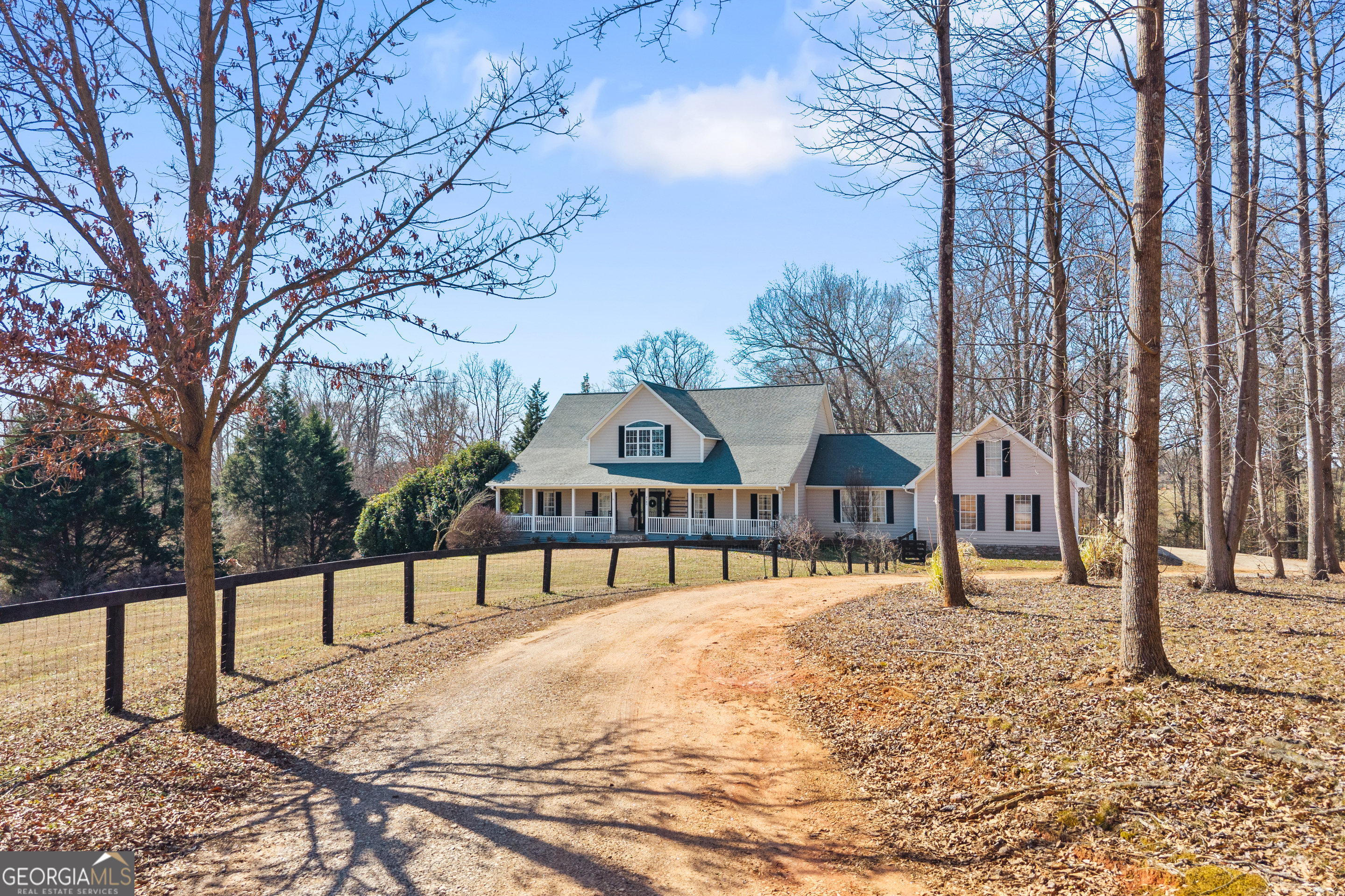 2565 New Franklin Church Road Canon, GA 30520 - Photo 143 of 168 a view of a large white house with a yard covered with snow in front of house
