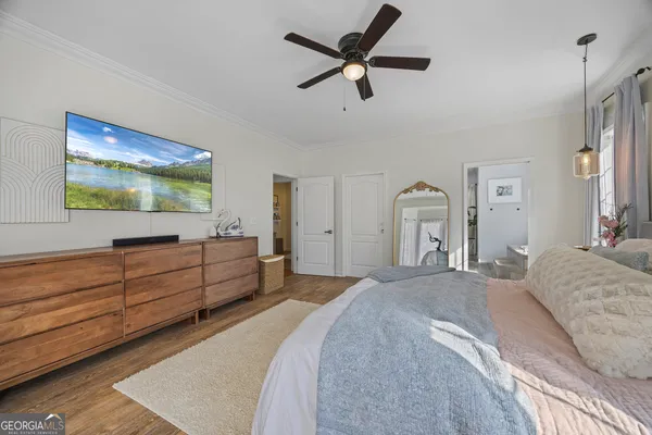 a view of a dining room with furniture a chandelier and wooden floor