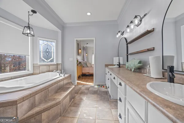 a kitchen with granite countertop white cabinets and stainless steel appliances