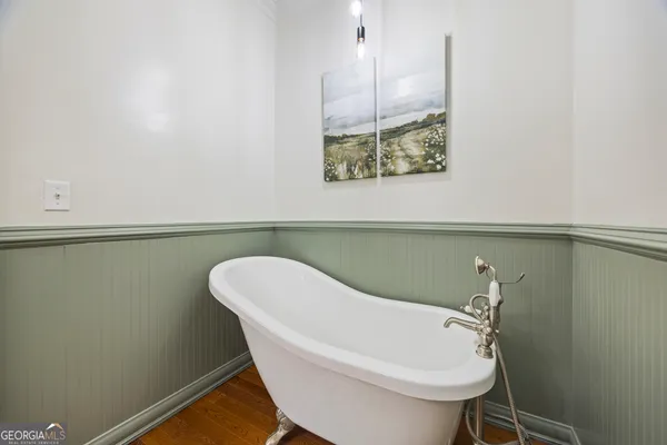 a bathroom with a granite countertop toilet sink and mirror