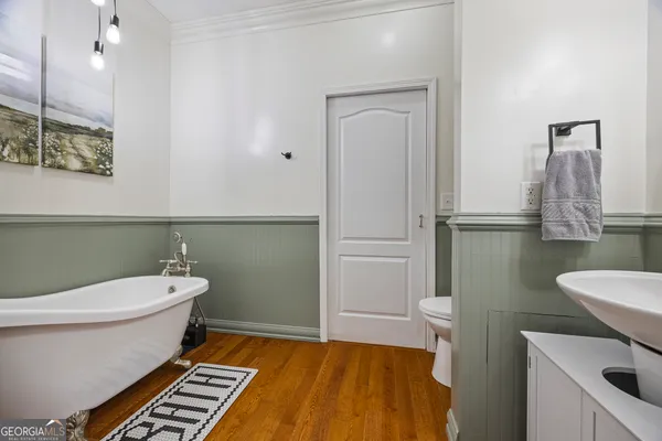 a living room with stainless steel appliances furniture and a window
