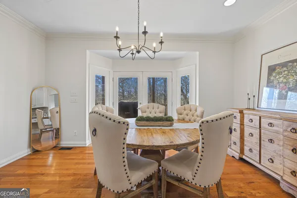 a backyard of a house with table and chairs