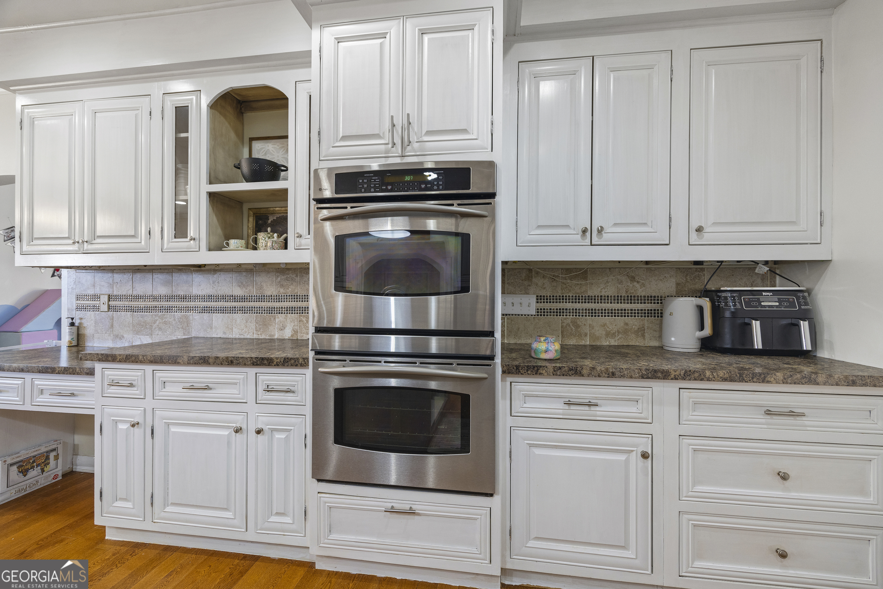 2565 New Franklin Church Road Canon, GA 30520 - Photo 58 of 168 a kitchen with granite countertop white cabinets and stainless steel appliances