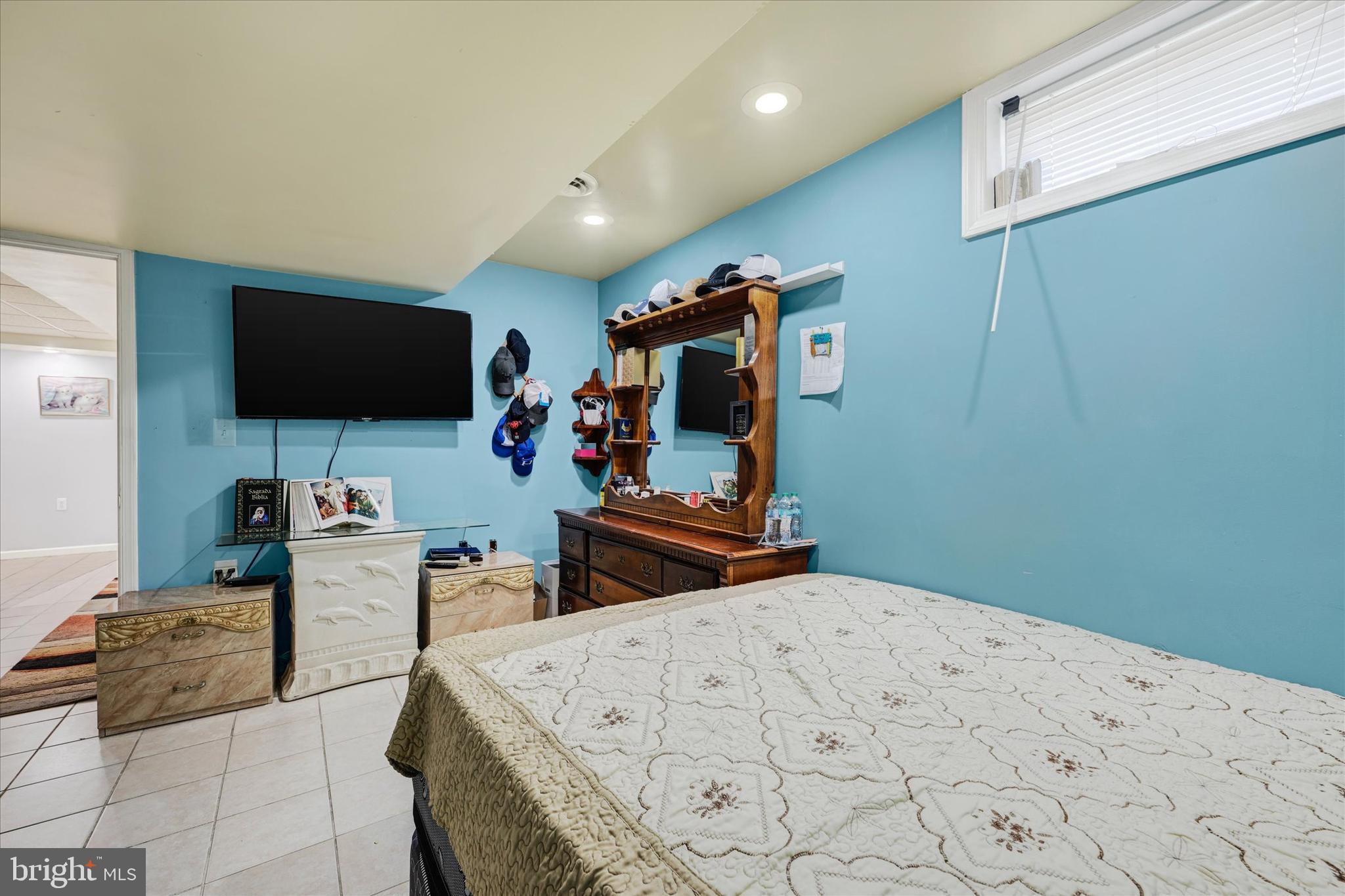 2838 Pennsylvania Avenue Baltimore, MD 21227 - Photo 20 of 32 a bedroom with bed and a flat tv screen on the dresser