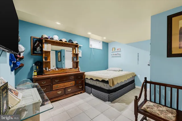 a living room with furniture a flat screen tv and paintings on the wall