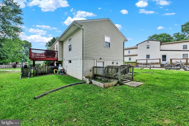a view of a house with a yard and sitting area