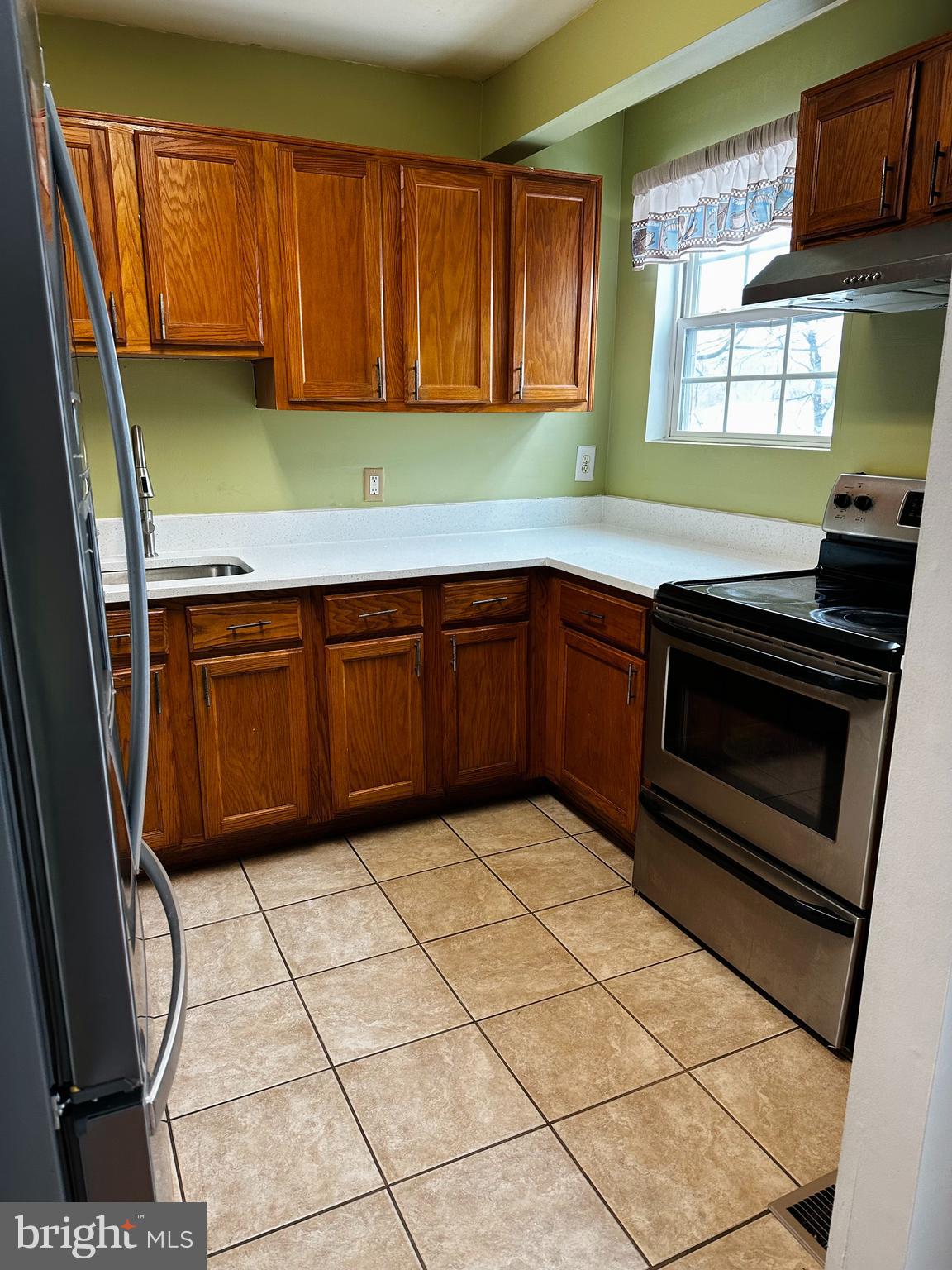 2838 Pennsylvania Avenue Baltimore, MD 21227 - Photo 28 of 32 a kitchen with stainless steel appliances granite countertop a stove a sink and a microwave