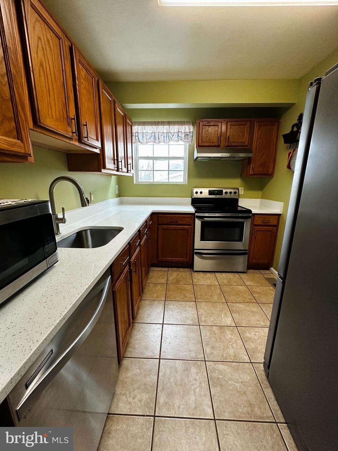 2838 Pennsylvania Avenue Baltimore, MD 21227 - Photo 29 of 32 a kitchen with stainless steel appliances granite countertop a sink and cabinets