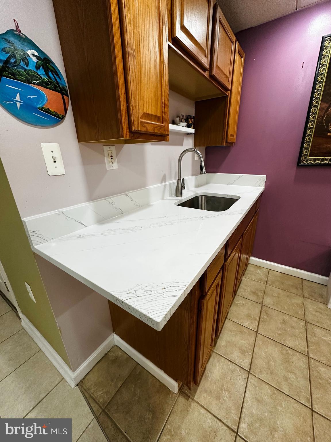 2838 Pennsylvania Avenue Baltimore, MD 21227 - Photo 30 of 32 a kitchen with a sink a stove and a microwave