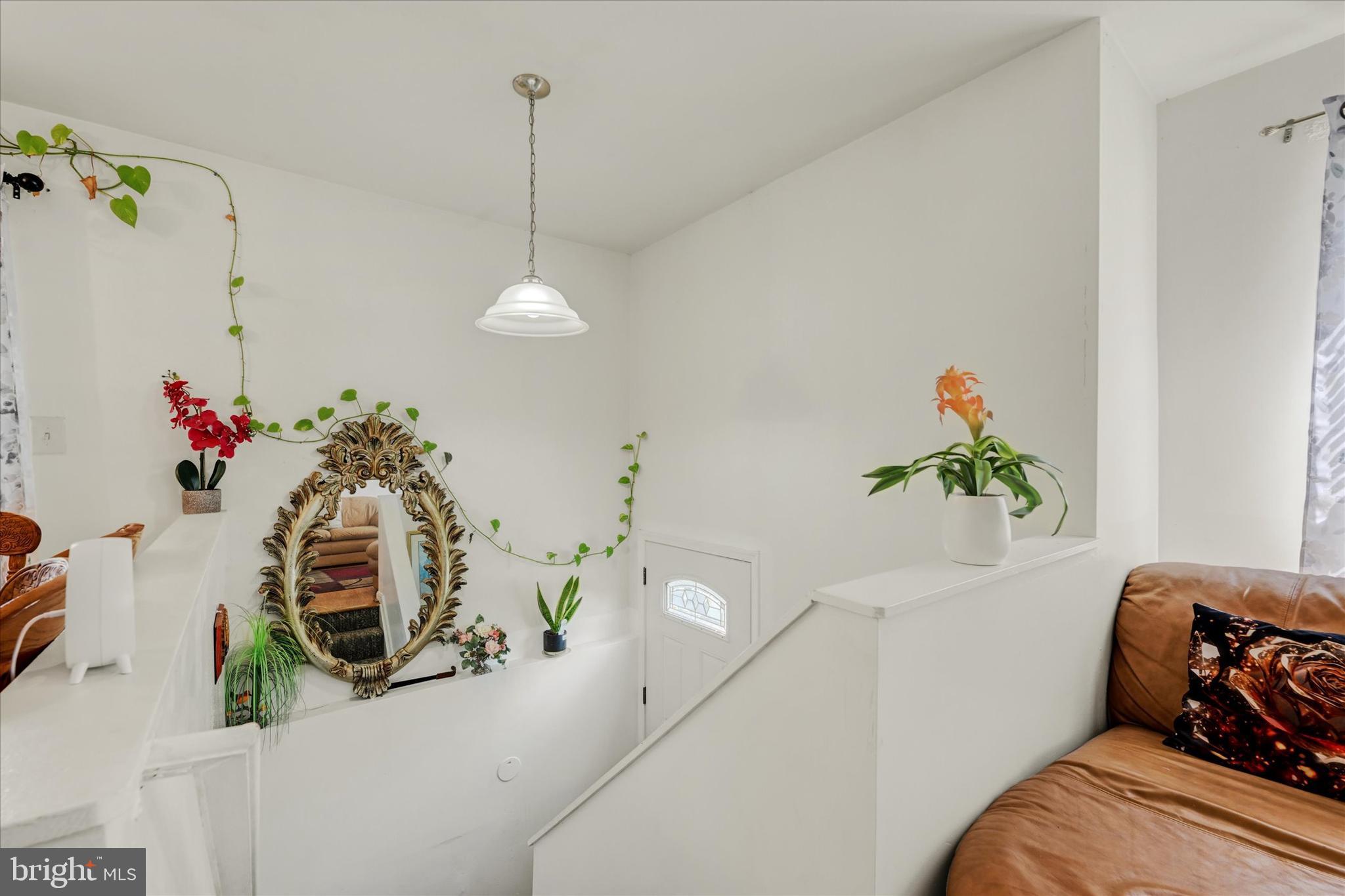 2838 Pennsylvania Avenue Baltimore, MD 21227 - Photo 5 of 32 a bedroom with furniture and a chandelier